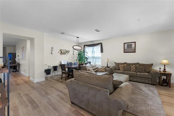 a living room with furniture and wooden floor