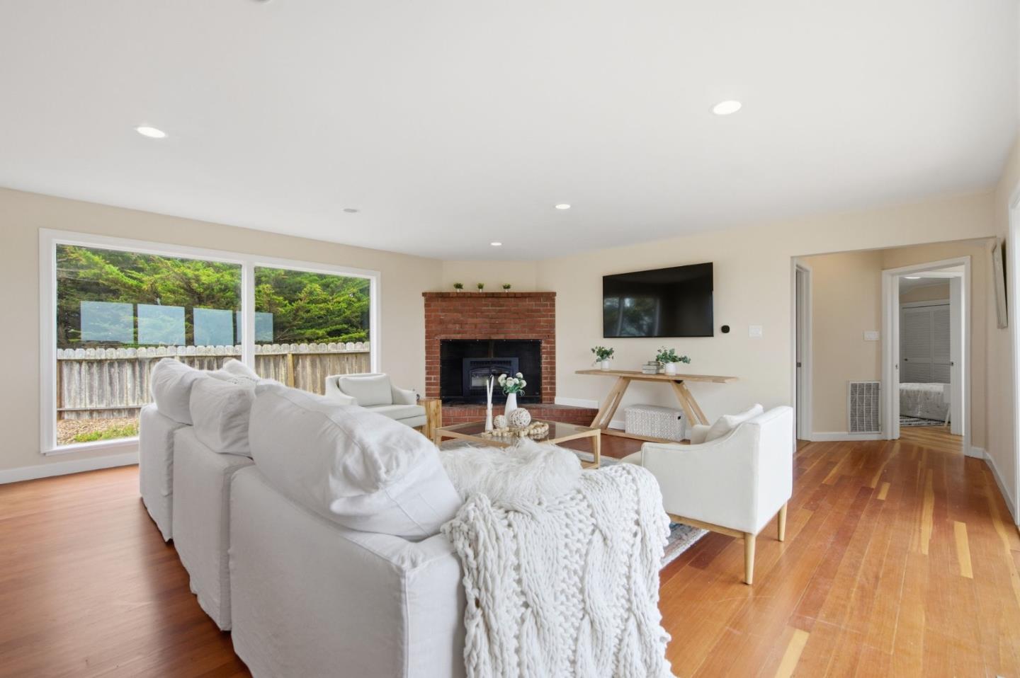 1263 Reservoir Road Pescadero, CA 94060 - Photo 21 of 66 a living room with furniture fireplace and a flat screen tv