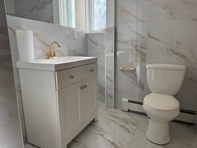 a bathroom with a sink toilet and a mirror