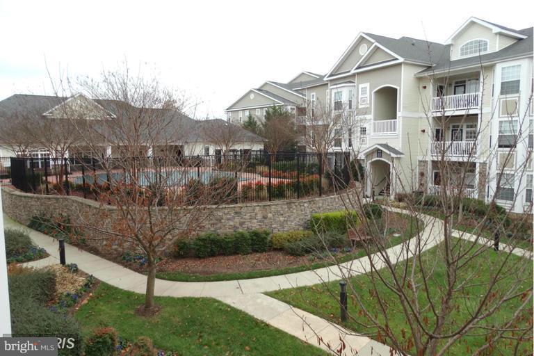 504 Sunset View Terrace Southeast, Unit 206 Leesburg, VA 20175 - Photo 1 of 18 a front view of a house with a yard