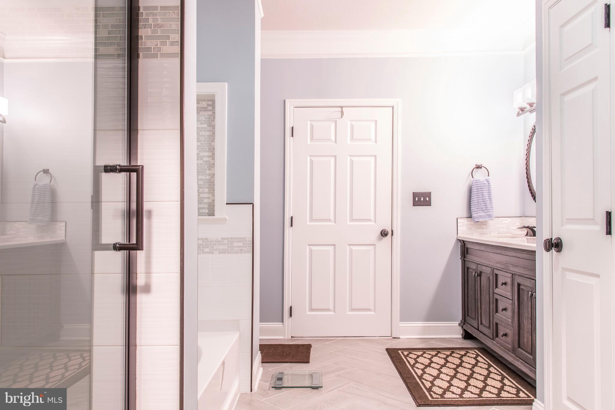 504 Sunset View Terrace Southeast, Unit 206 Leesburg, VA 20175 - Photo 12 of 18 a view of a bedroom with wooden floor and white walls