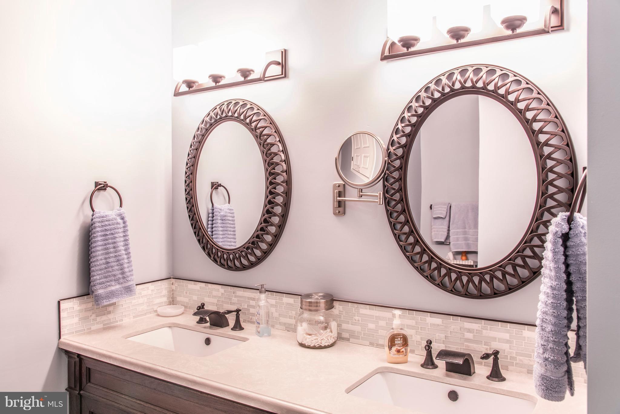 504 Sunset View Terrace Southeast, Unit 206 Leesburg, VA 20175 - Photo 14 of 18 a bathroom with a sink and a mirror