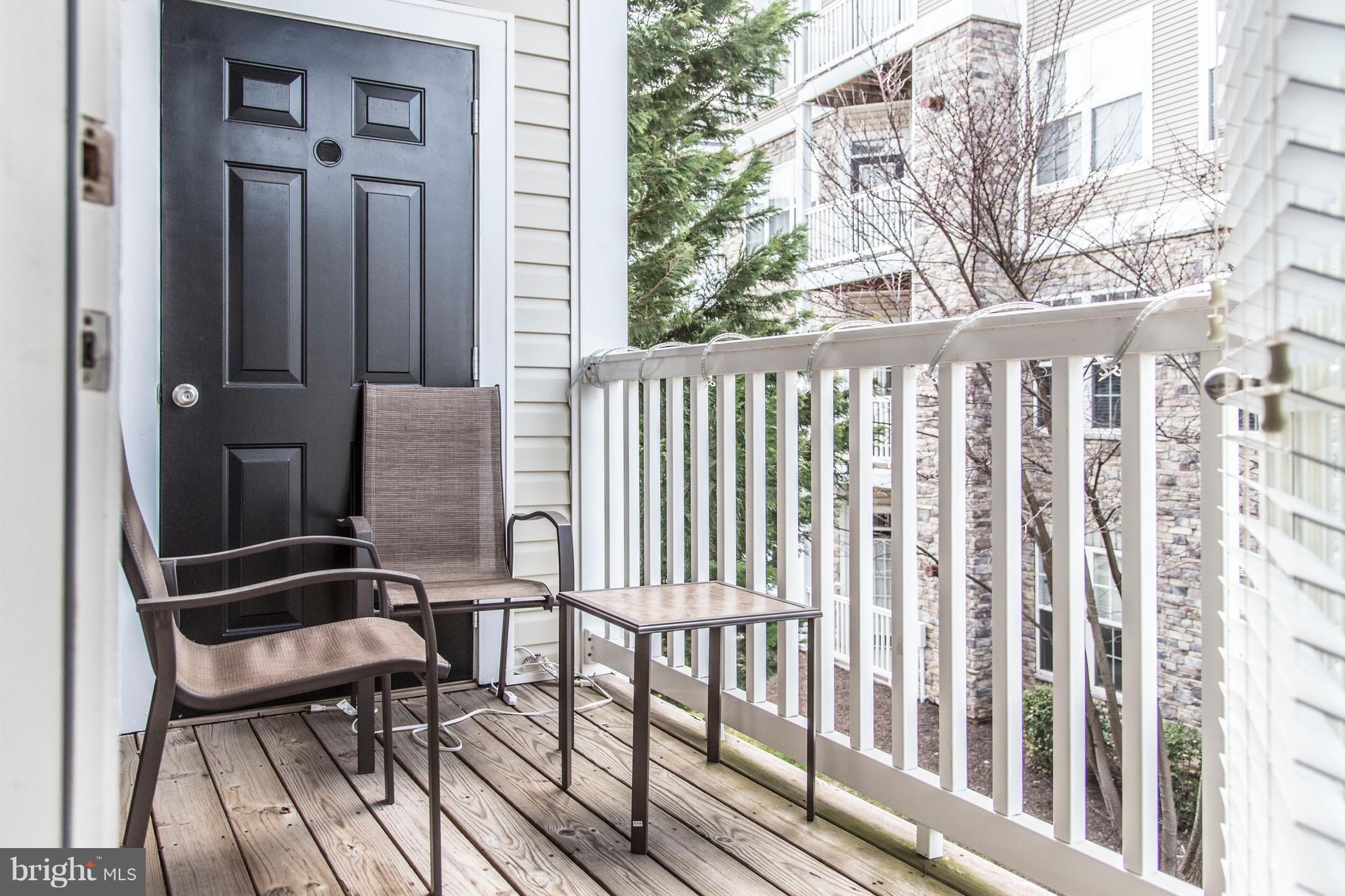 504 Sunset View Terrace Southeast, Unit 206 Leesburg, VA 20175 - Photo 18 of 18 a view of a chair and table in the balcony