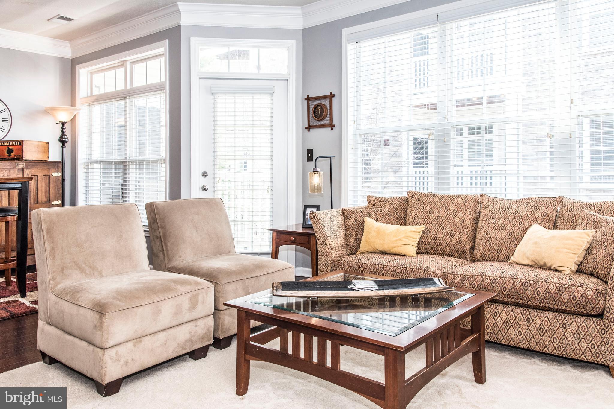 504 Sunset View Terrace Southeast, Unit 206 Leesburg, VA 20175 - Photo 8 of 18 a living room with furniture and a large window