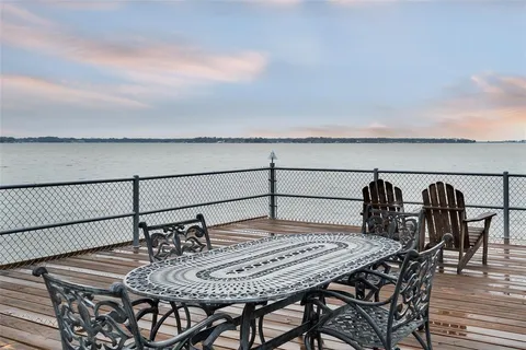 a view of a patio with table and chairs with wooden floor