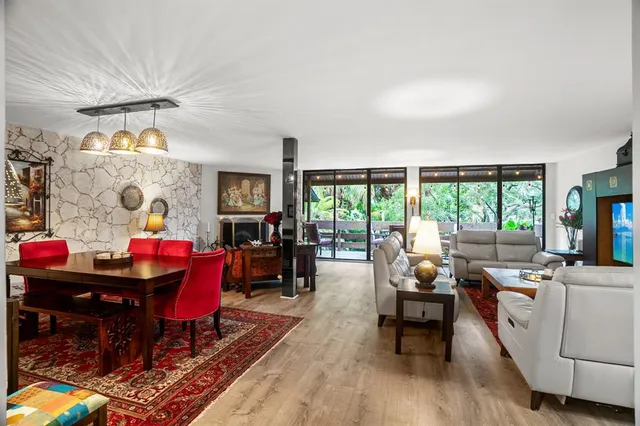 a living room filled with furniture and a large window