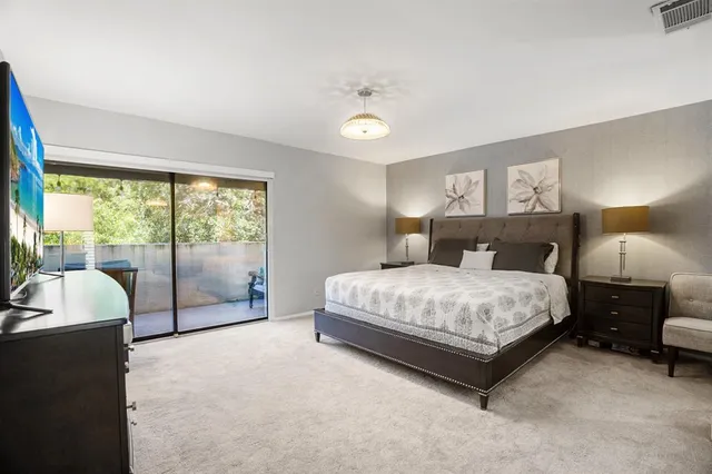 a bedroom with a bed and a lamp