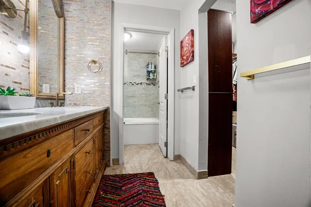 a bathroom with a sink a mirror and a shower