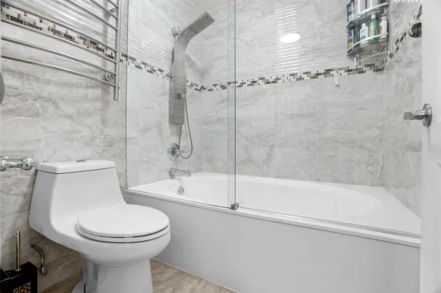 a bathroom with a toilet and shower