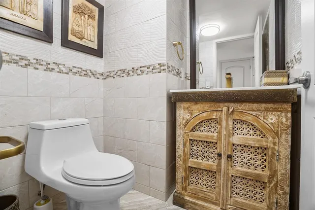 a bathroom with a toilet sink and shower