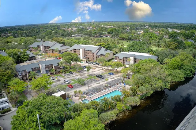 an aerial view of residential houses with outdoor space and street view
