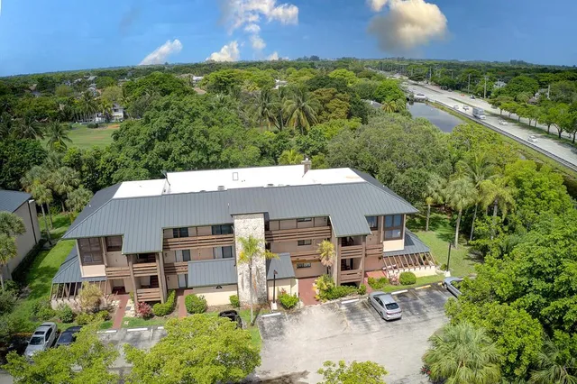 an aerial view of a house with garden space and street view