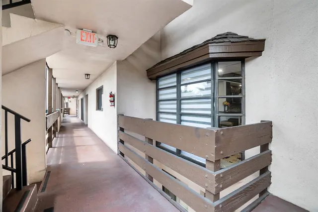 a view of bedroom and hall with wooden floor