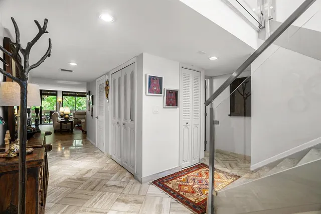 a view of a hallway view with living area and entryway
