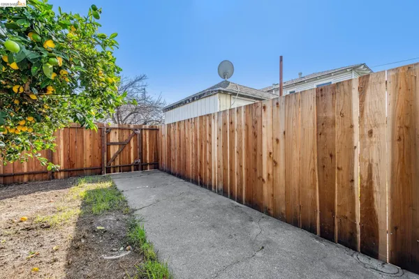 a view of a house with brick walls and a yard with plants