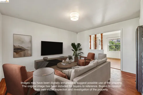 a living room with furniture kitchen view and a large window