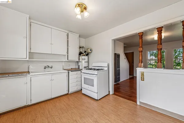 a kitchen with white cabinets and white appliances