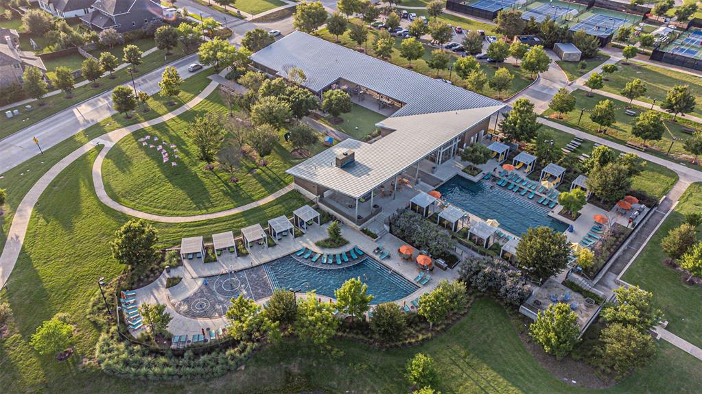1070 Adair Road Prosper, TX 75078 - Photo 40 of 40 Expansive community amenity center featuring a contemporary architectural style, multiple outdoor pools, private cabanas, and extensive green spaces with walking paths