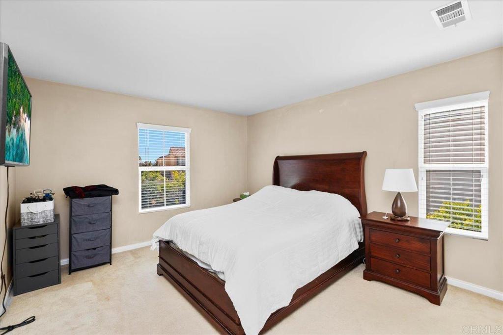 838 Luminara Way San Marcos, CA 92078 - Photo 43 of 54 a bedroom with a bed and two windows