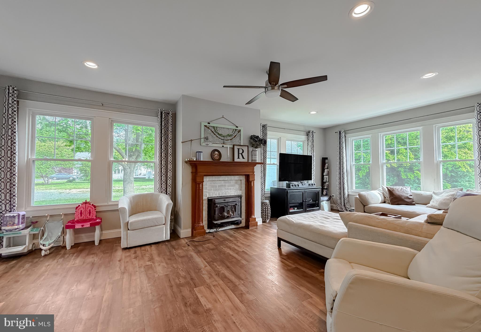 16146 Thomas Road Piney Point, MD 20674 - Photo 16 of 57 a living room with furniture window and a fireplace