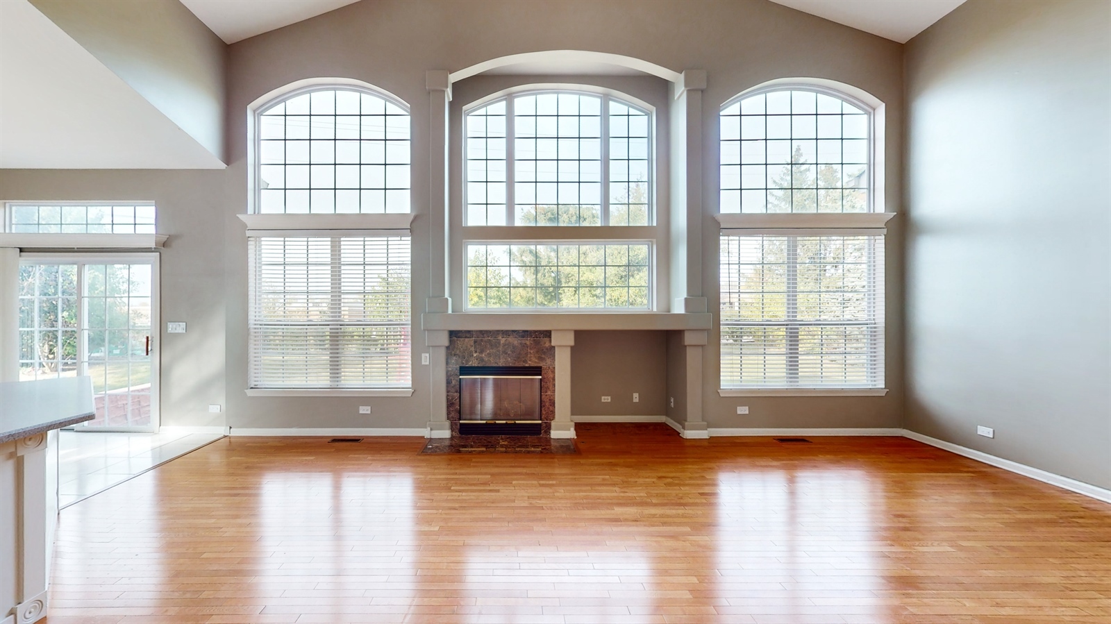 627 Conestoga Road Naperville, IL 60563 - Photo 5 of 46 an empty room with wooden floor and windows