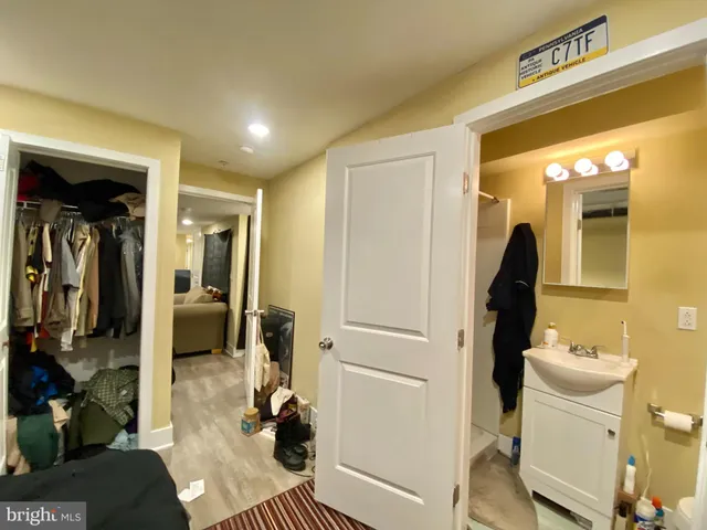 a bathroom with a toilet a sink and mirror