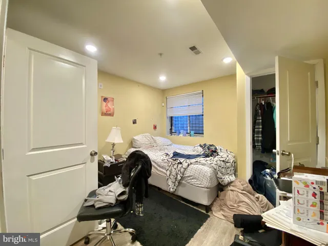 a bedroom with furniture and a window