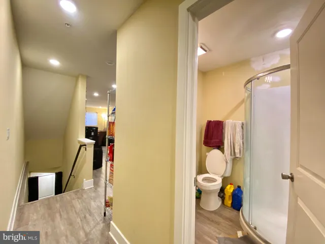 a bathroom with a toilet sink and a mirror
