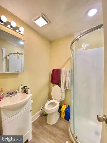 a bathroom with a toilet sink and shower curtain
