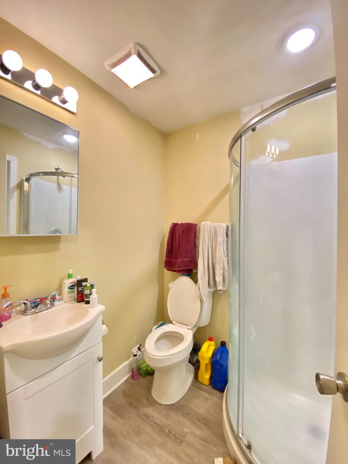 2214 North Camac Street, Unit A Philadelphia, PA 19133 - Photo 6 of 18 a bathroom with a toilet sink and shower curtain