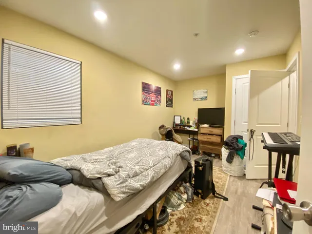 a bedroom with bed and a flat screen tv