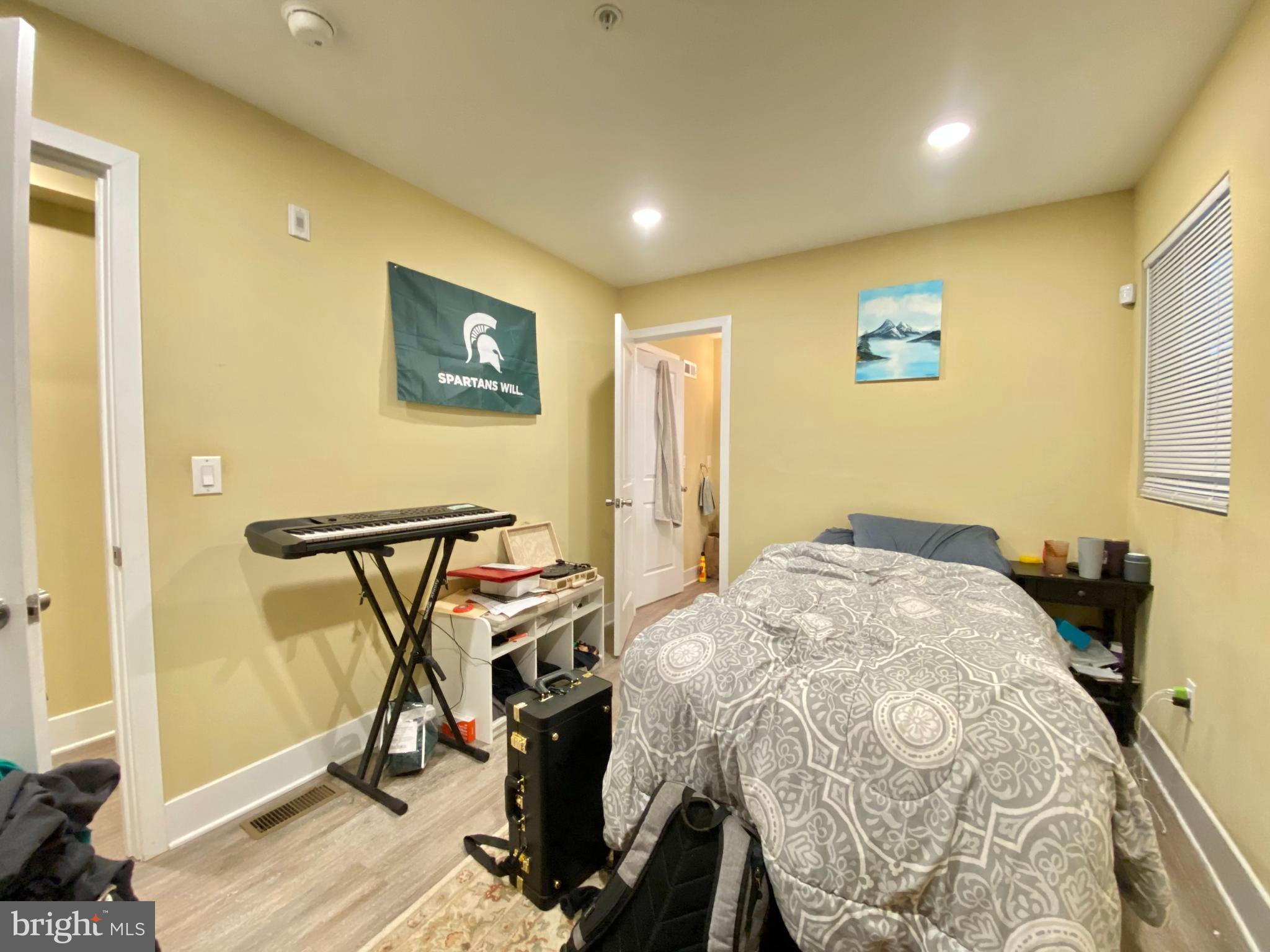 2214 North Camac Street, Unit A Philadelphia, PA 19133 - Photo 9 of 18 a bedroom with a bed and a table