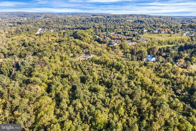 an aerial view of residential houses with city view