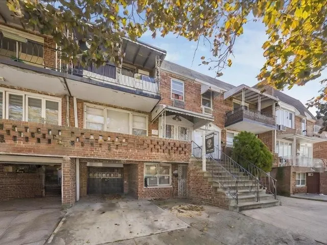 a front view of a building with a garden