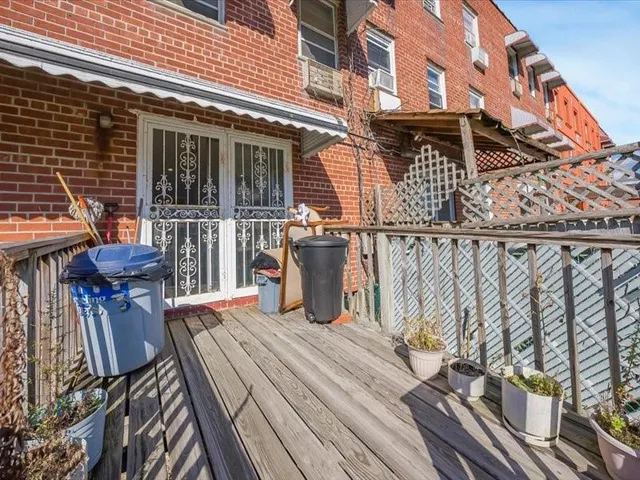 a view of a roof deck with table and chairs and wooden floor