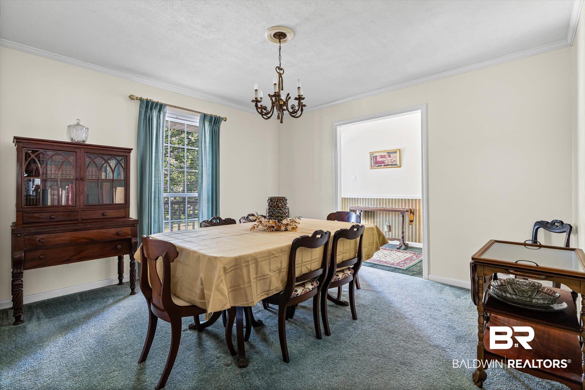 431 Simms Drive Saraland, AL 36571 - Photo 5 of 34 Carpeted dining room with ornamental molding, a chandelier, and a textured ceiling