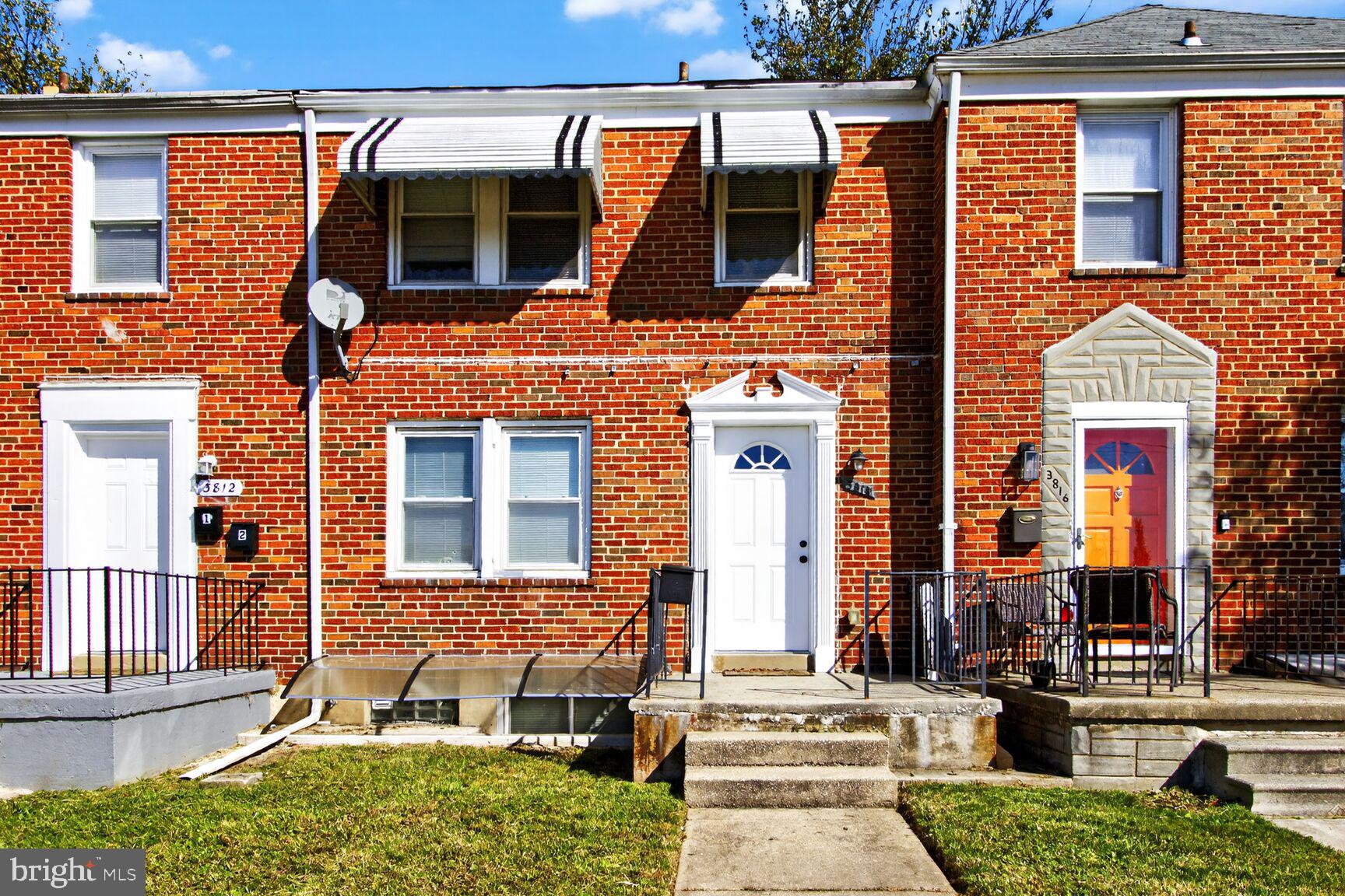 front view of a brick house with a fountain