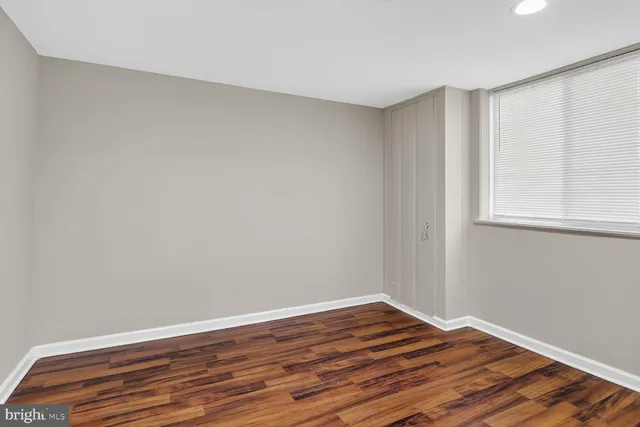a view of wooden floor and windows in a room