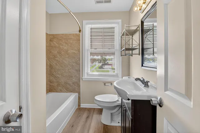 a bathroom with a sink toilet and bathtub