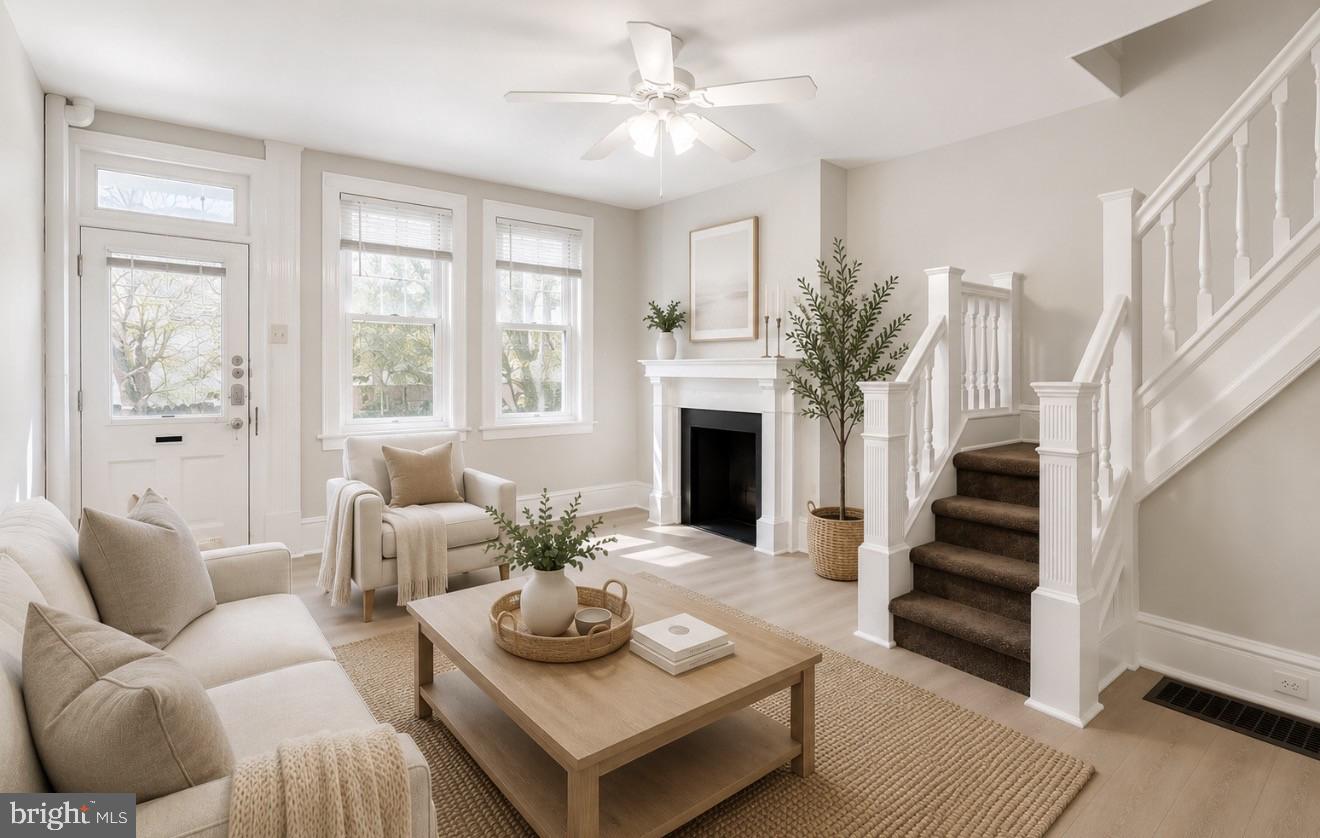 4817 Ridge Avenue Philadelphia, PA 19129 - Photo 3 of 34 a living room with furniture a fireplace and a large window