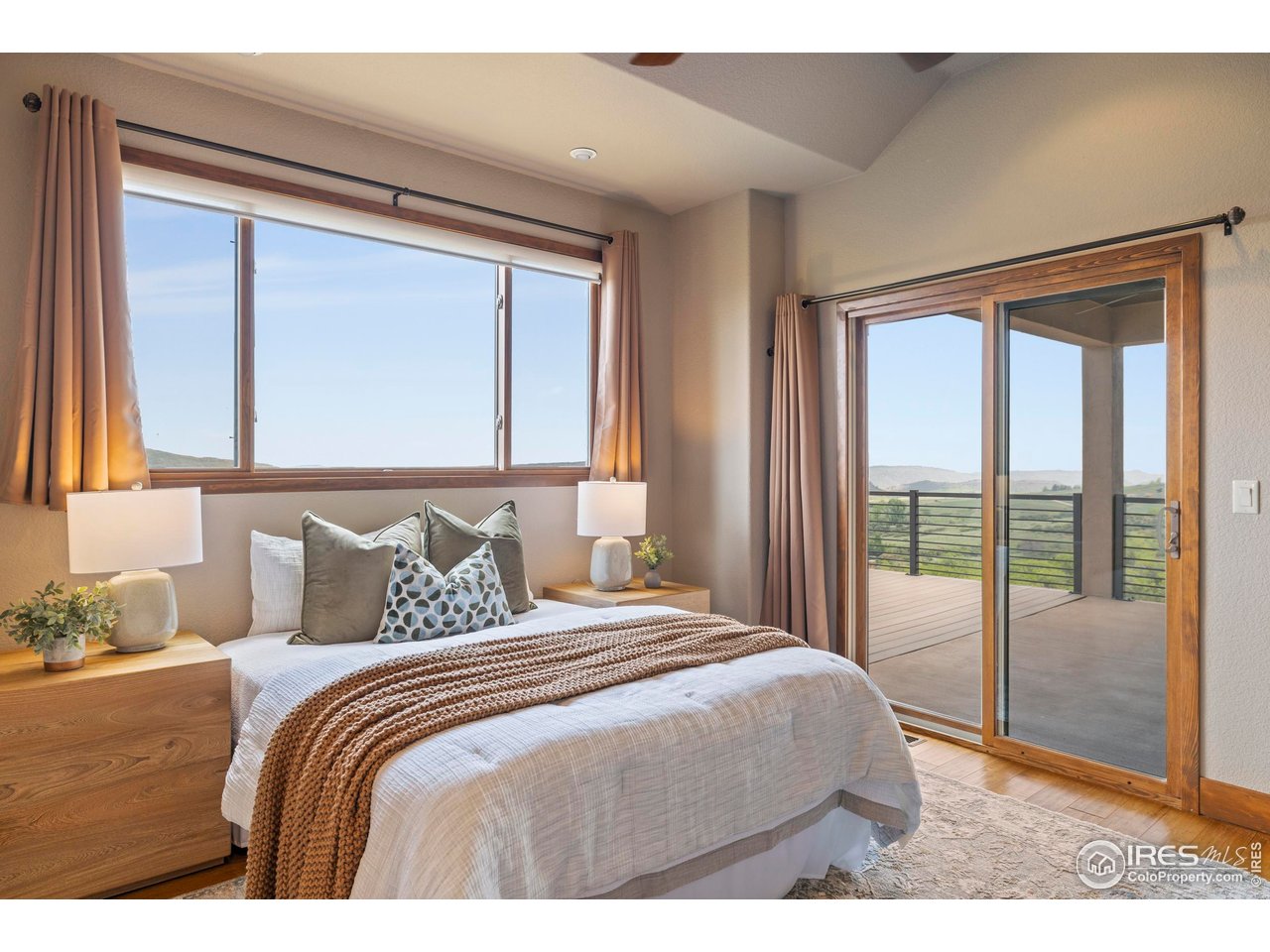 183 Red Bear Road Laporte, CO 80535 - Photo 11 of 32 a bedroom with a large bed and a large window