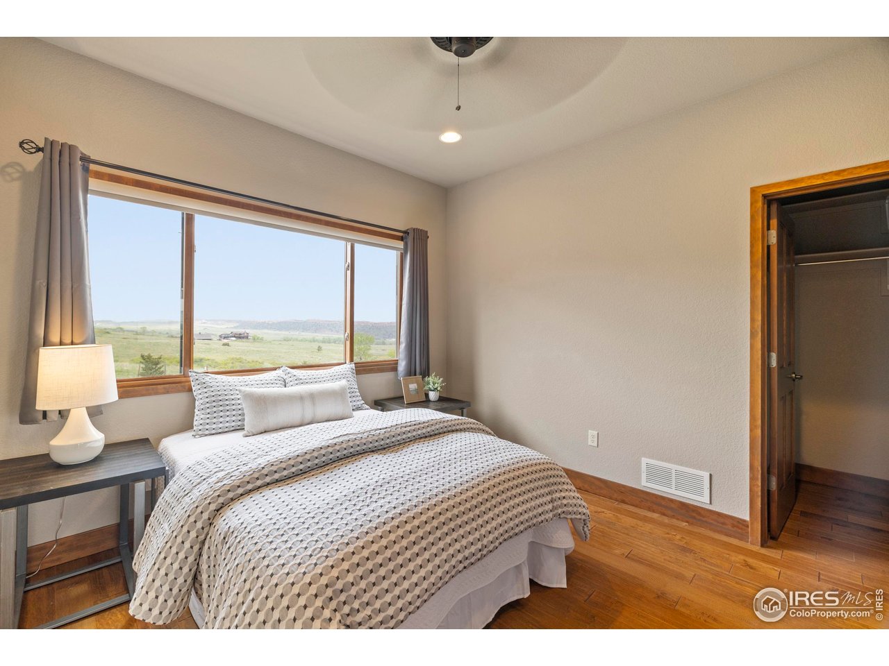 183 Red Bear Road Laporte, CO 80535 - Photo 14 of 32 a bedroom with a large bed and a large window