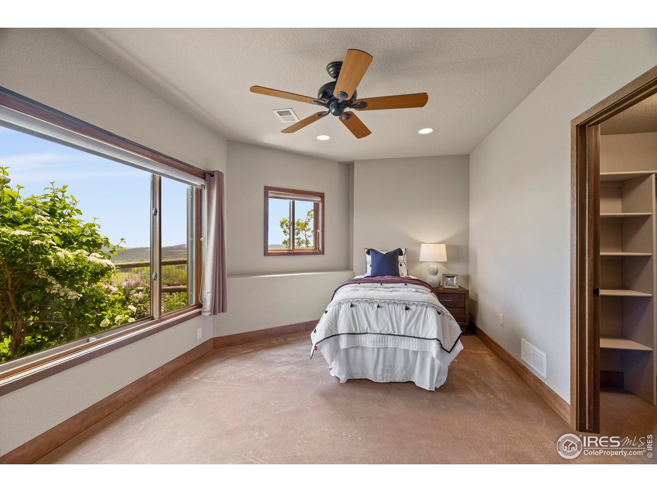 183 Red Bear Road Laporte, CO 80535 - Photo 19 of 32 a living room with a bed furniture and a window