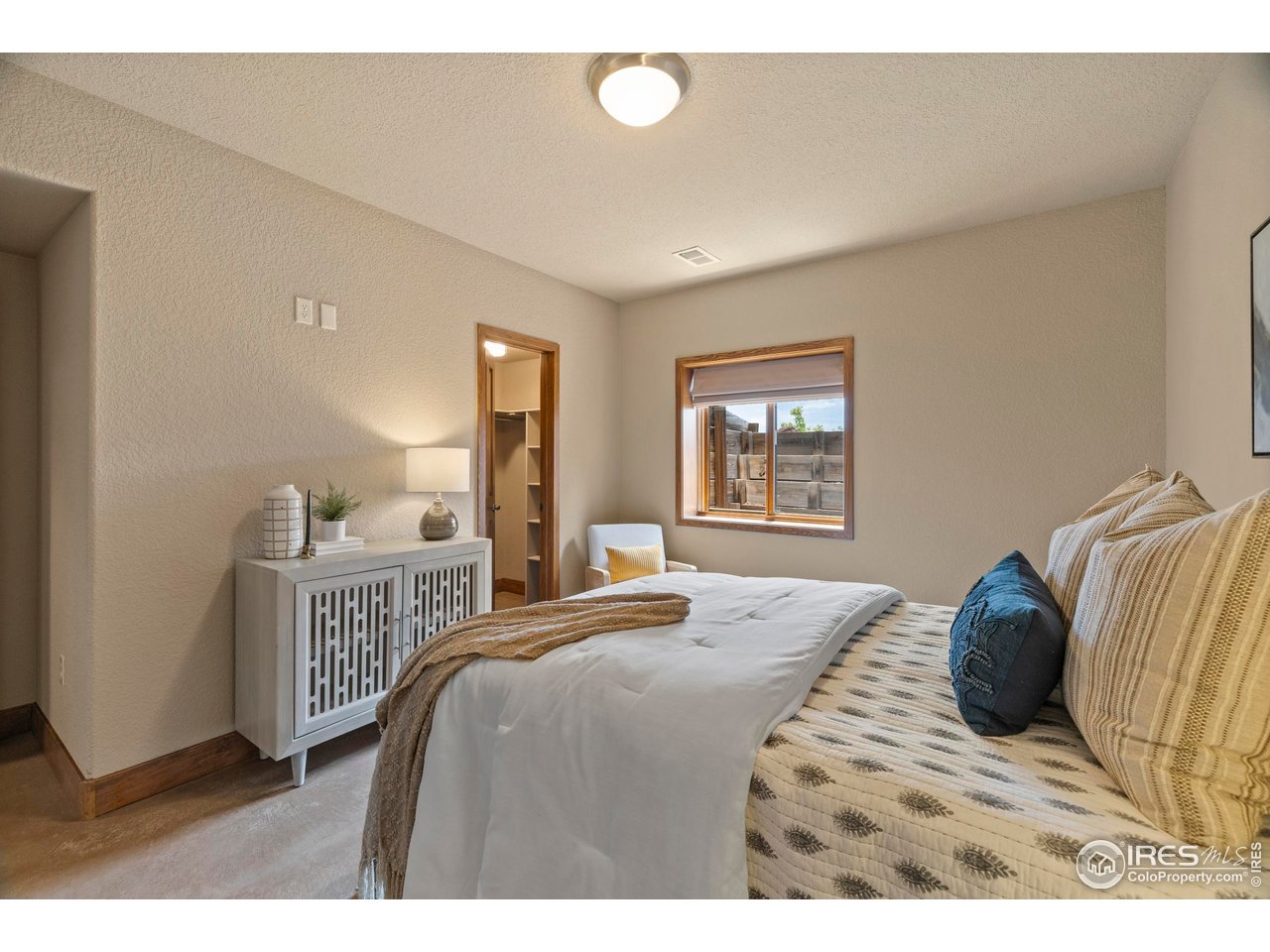 183 Red Bear Road Laporte, CO 80535 - Photo 21 of 32 a bedroom with a bed and a dresser with a bookshelf