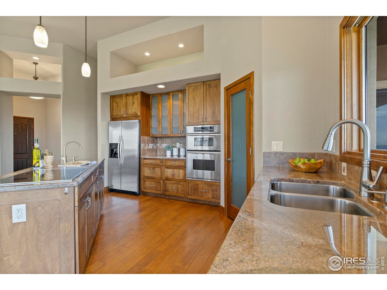 183 Red Bear Road Laporte, CO 80535 - Photo 22 of 32 a kitchen with stainless steel appliances granite countertop a refrigerator and a sink