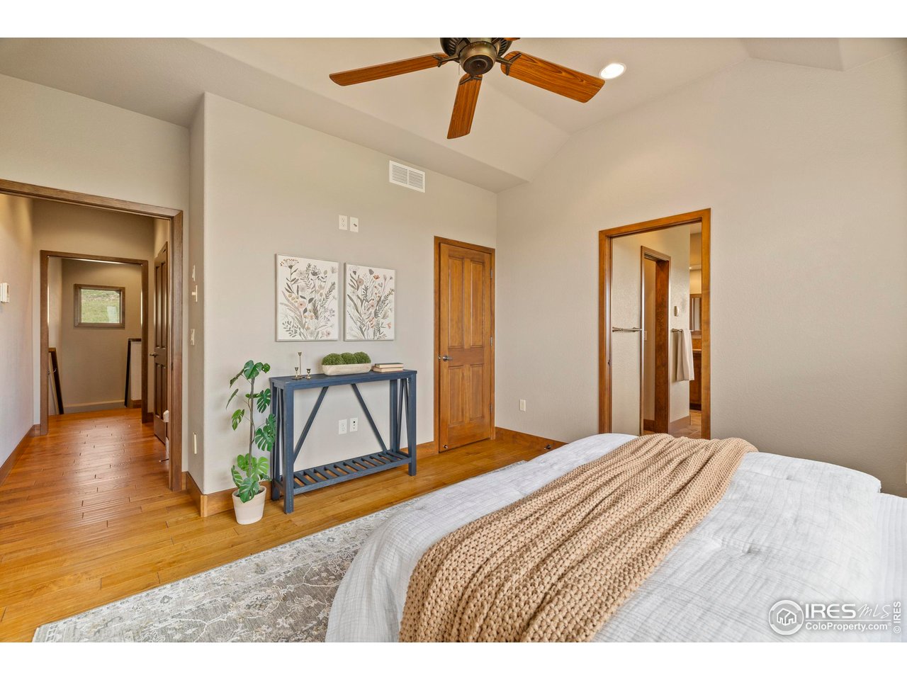 183 Red Bear Road Laporte, CO 80535 - Photo 24 of 32 a bedroom with a bed and wooden floor