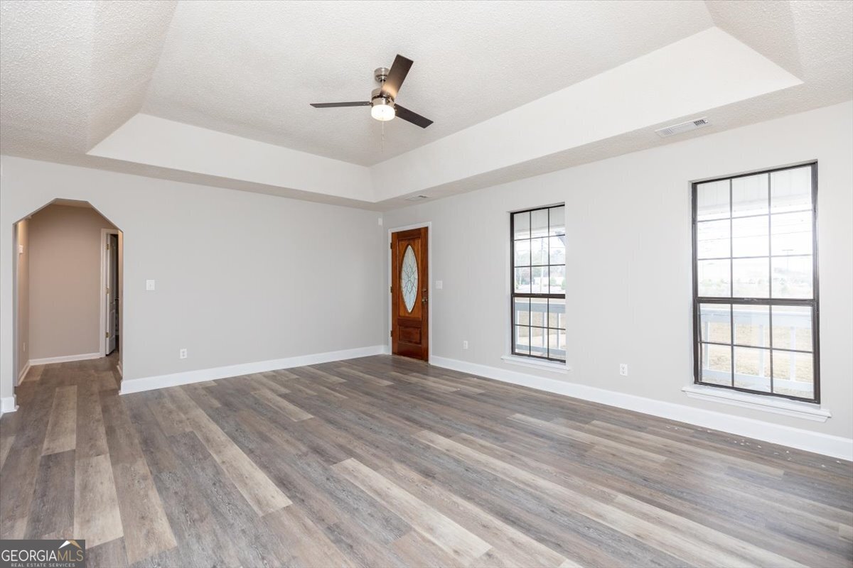 1027 Kathryn Ryals Road Warner Robins, GA 31088 - Photo 11 of 54 a view of an empty room with wooden floor and a window