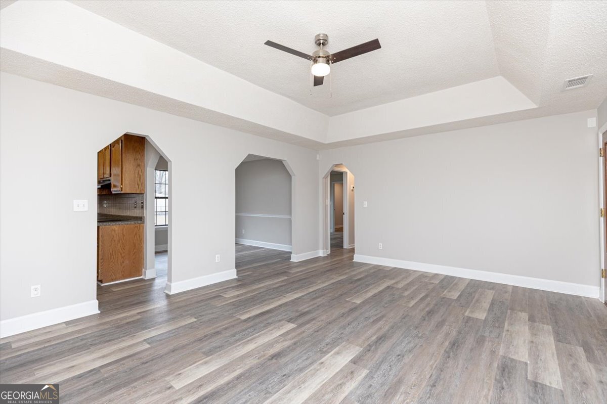 1027 Kathryn Ryals Road Warner Robins, GA 31088 - Photo 12 of 54 a view of a livingroom with wooden floor and a ceiling fan