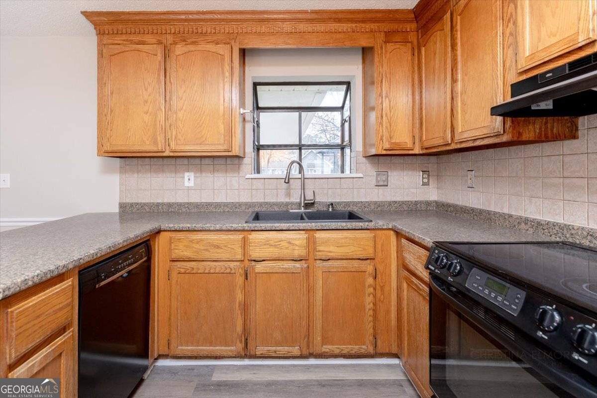 1027 Kathryn Ryals Road Warner Robins, GA 31088 - Photo 15 of 54 a kitchen with stainless steel appliances granite countertop a sink stove and cabinets