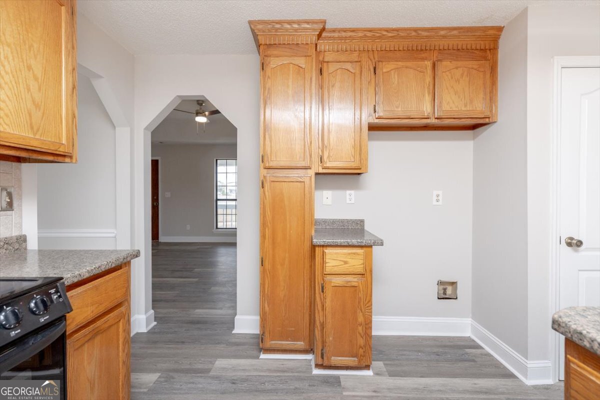 1027 Kathryn Ryals Road Warner Robins, GA 31088 - Photo 19 of 54 a view of a kitchen with wooden floor and staircase